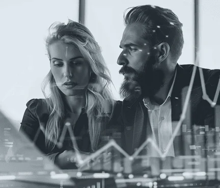 Corporate finance experts reviewing market analytics and portfolio data on a laptop screen.