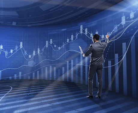Trader viewing large digital blue abstract background lines representing financial growth curves.